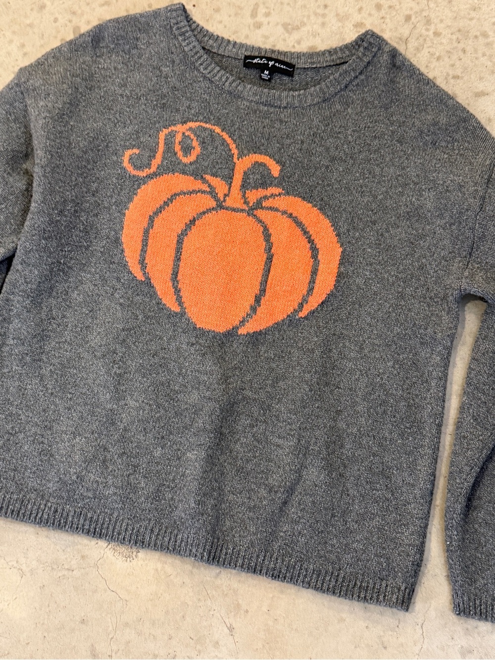 gray sweater with orange pumpkin motif